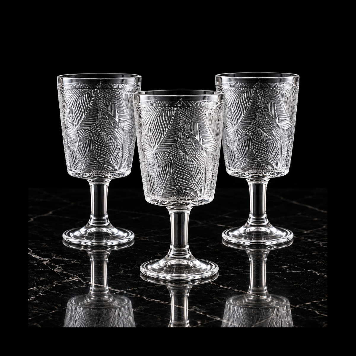 Glass goblets on black marble