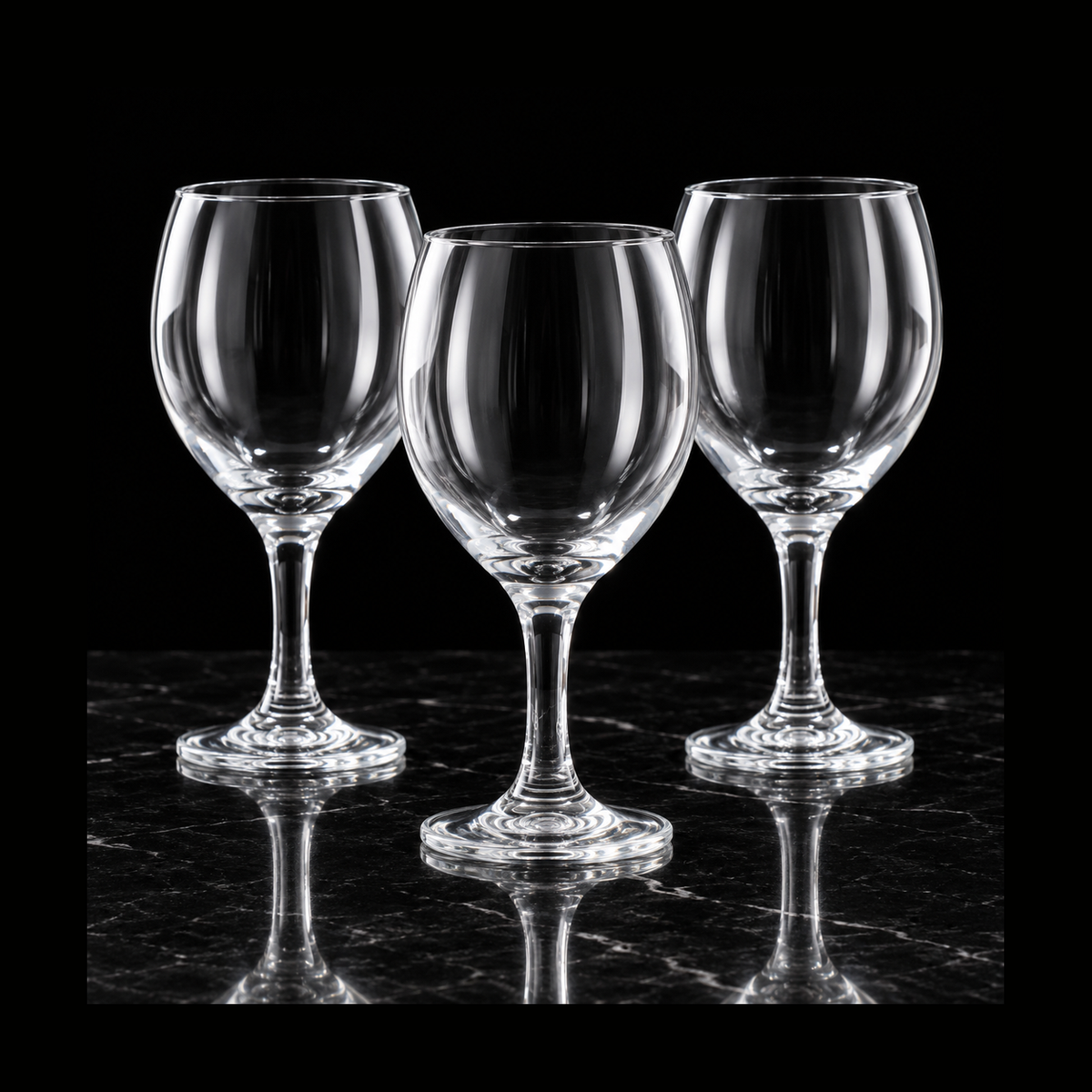 Clear wine goblets on black marble