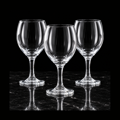 Clear wine goblets on black marble