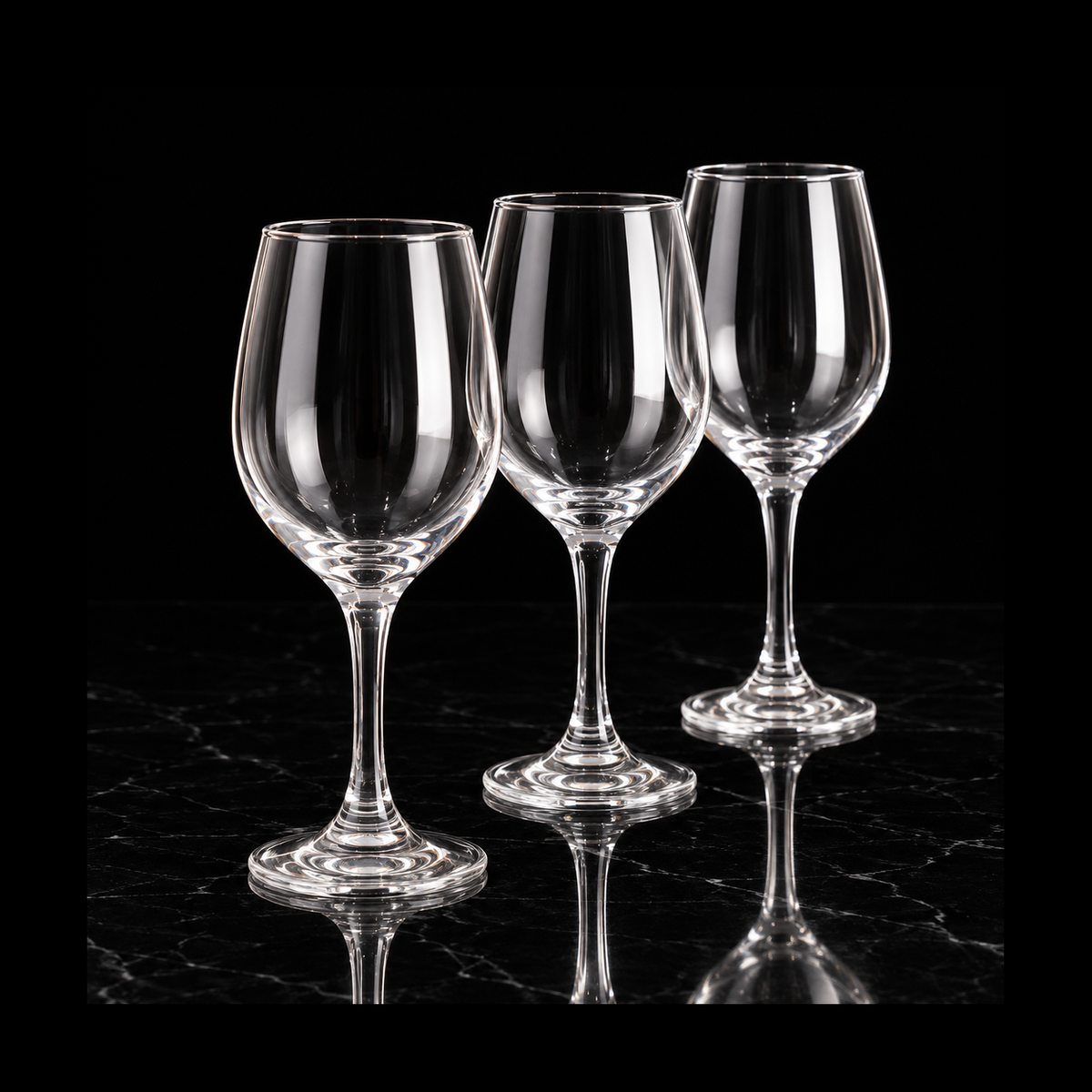 Clear wine glasses on black marble