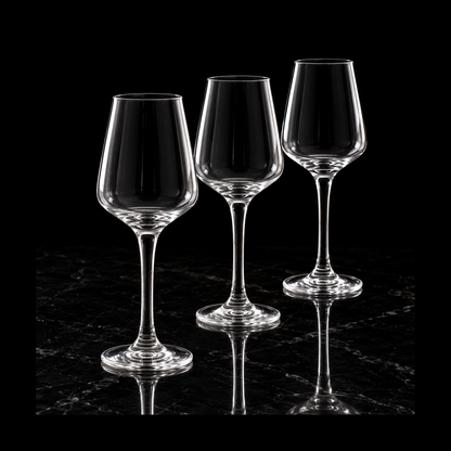 Clear tulip stemmed glasses on black marble