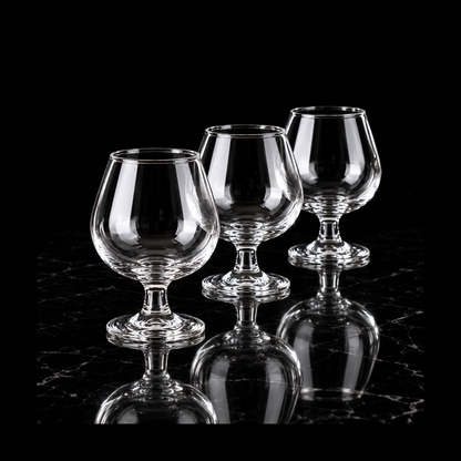 Clear snifter glasses on black marble