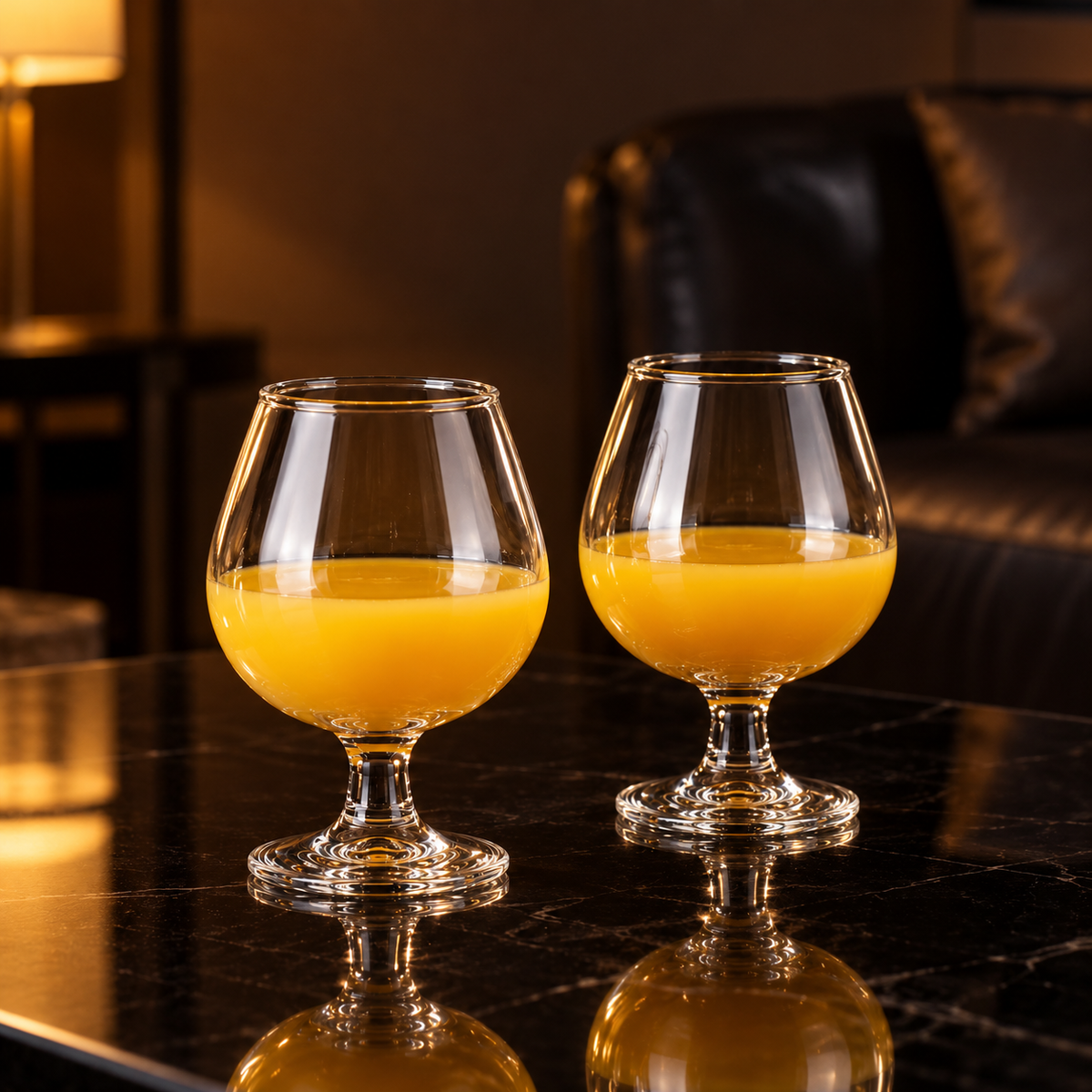 Snifter glasses with mango juice in a living room
