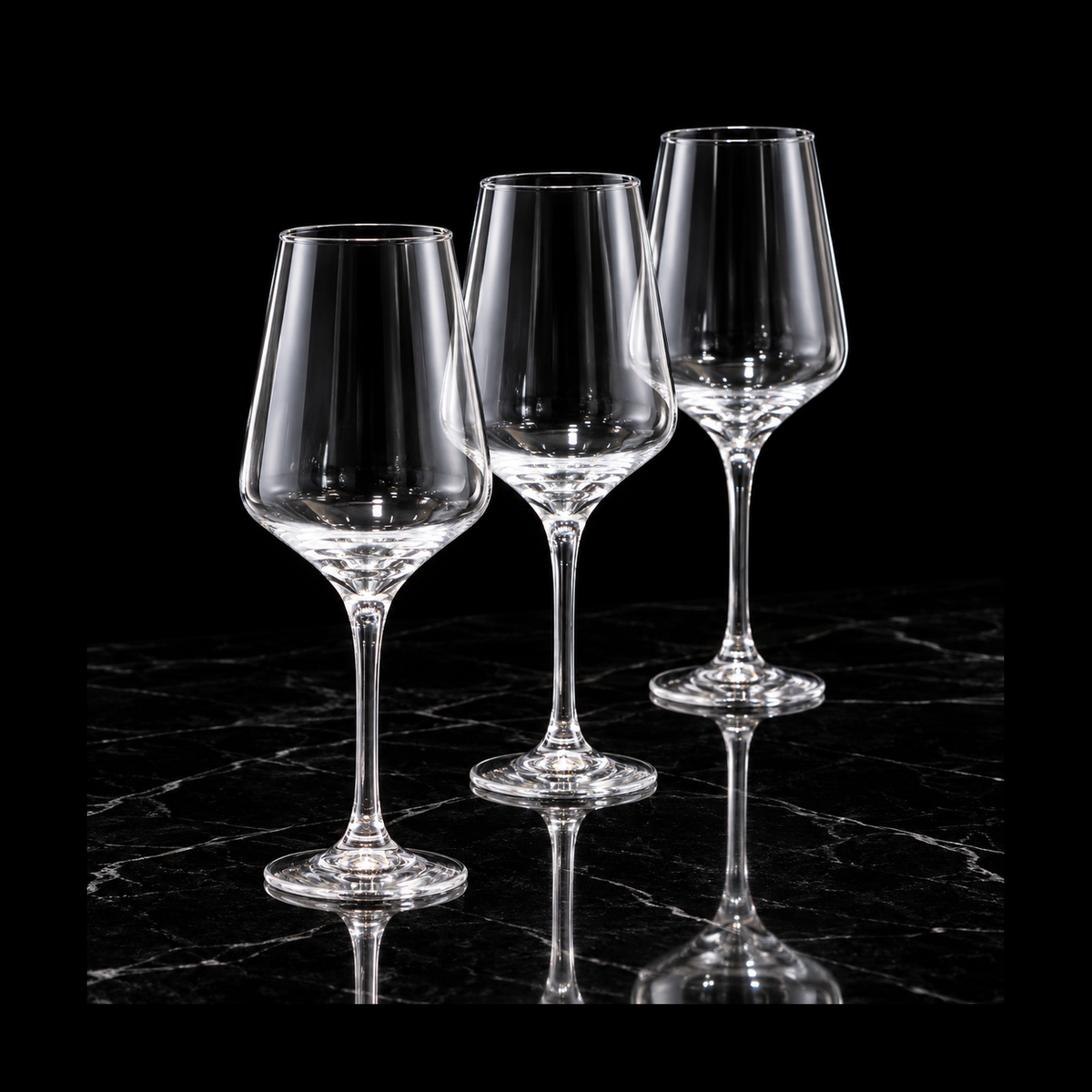 Clear tulip glasses on black marble