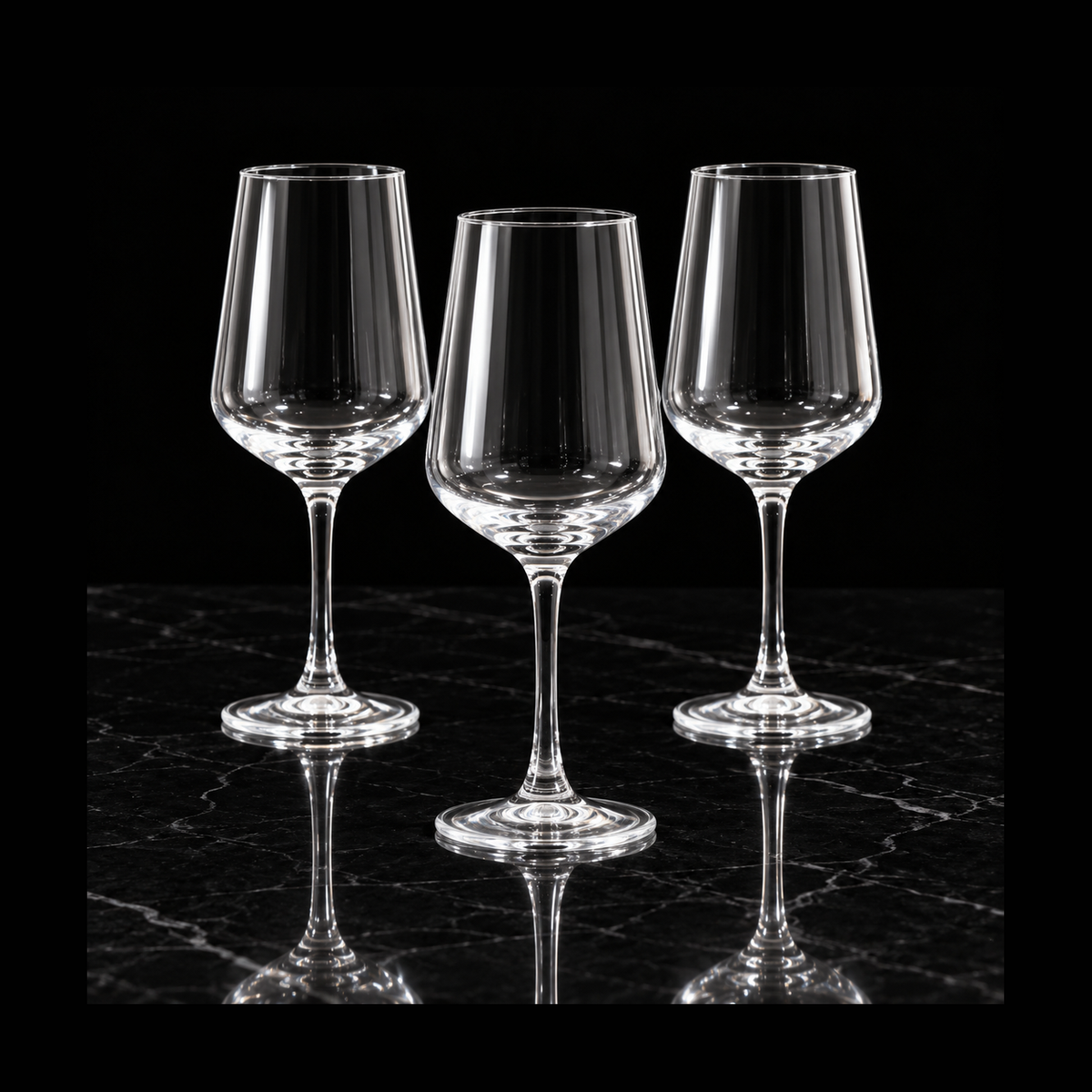 Clear wine glasses on black marble