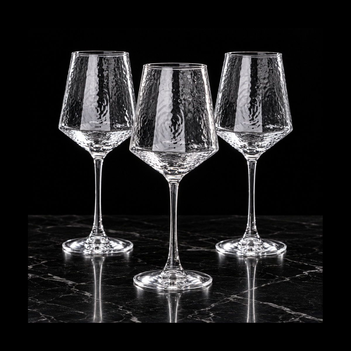 Hammered wine glasses on black marble
