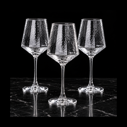 Hammered wine glasses on black marble