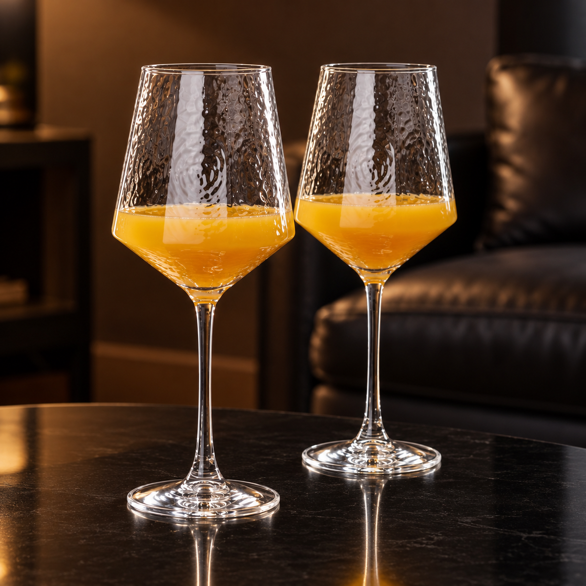 Hammered wine glasses with orange juice in a living room