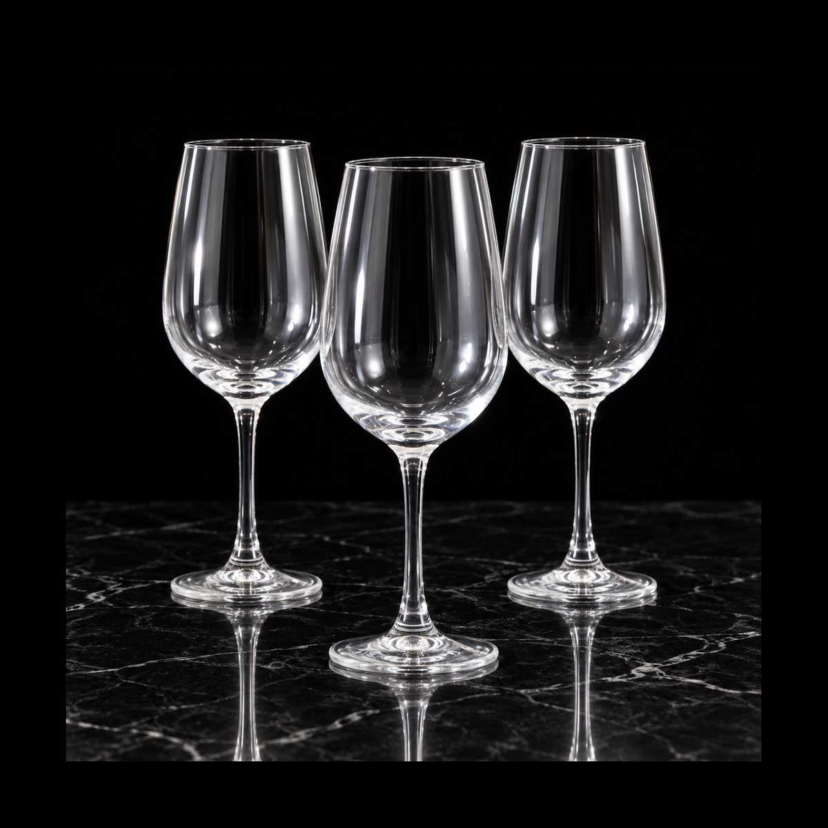 Clear wine glasses on black marble