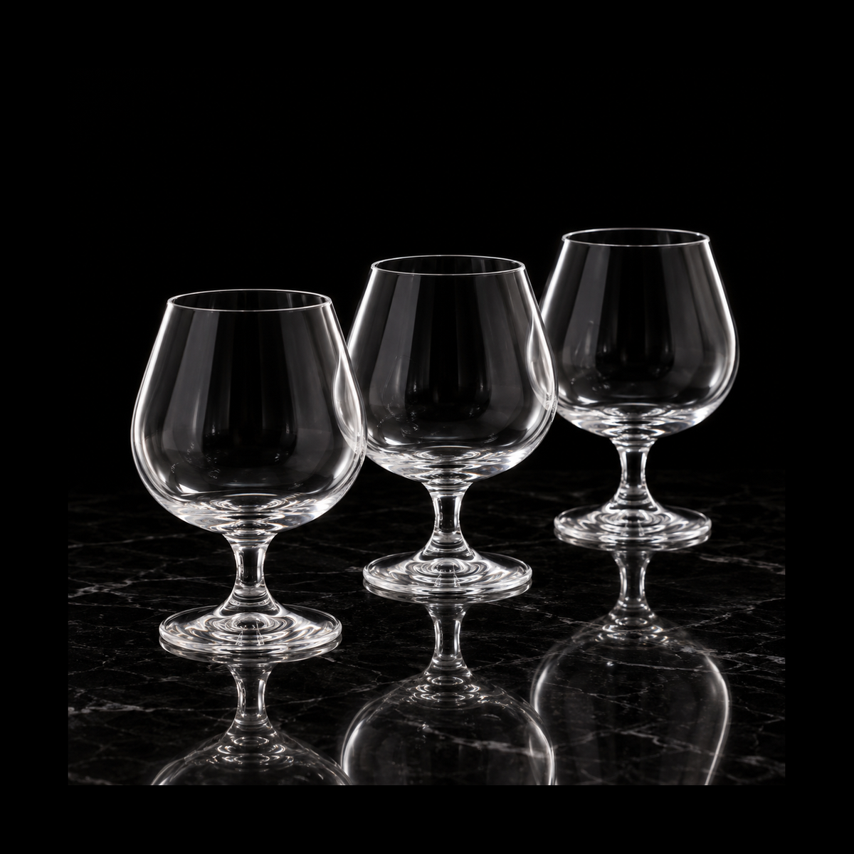 Crystal snifters on black marble