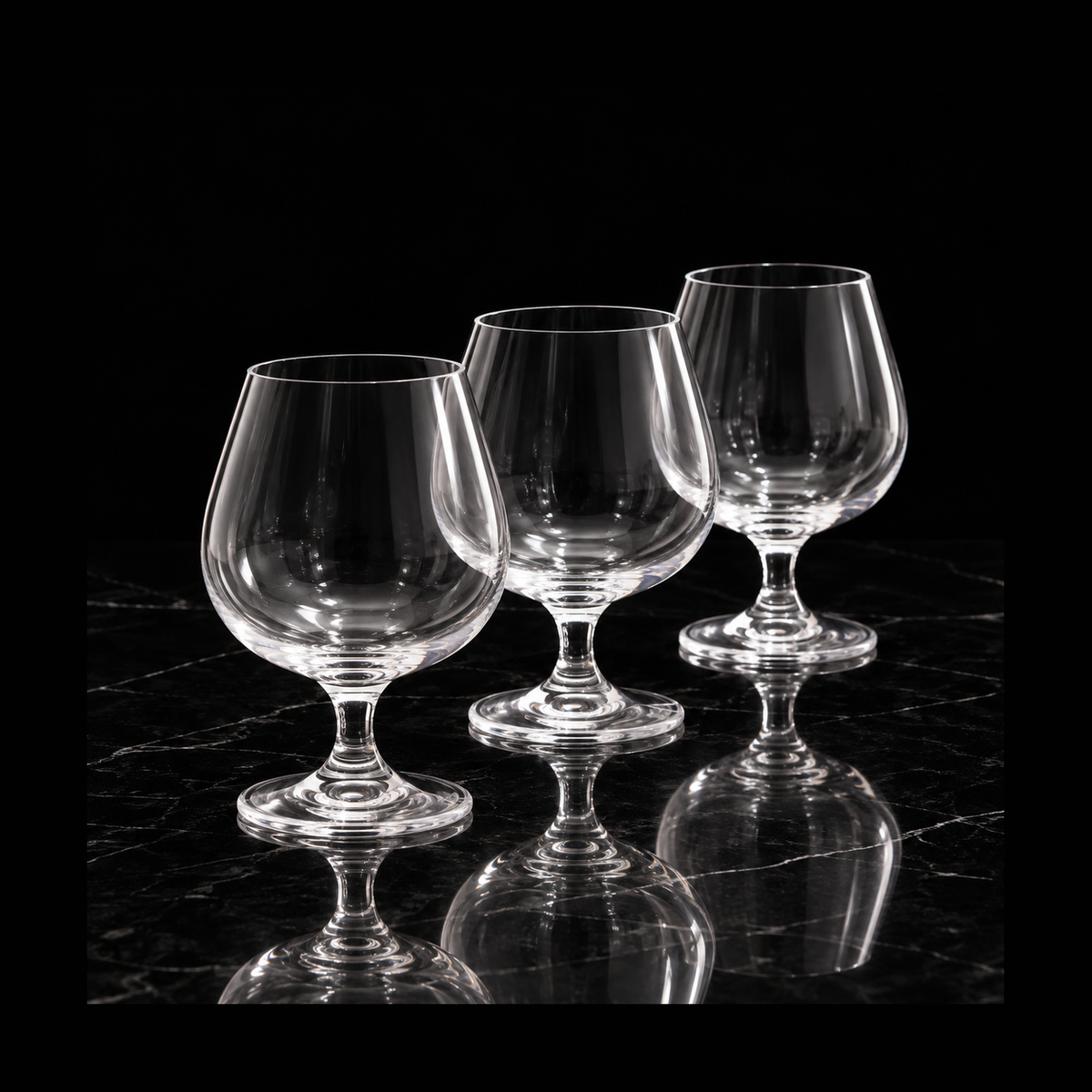 Crystal snifters on black marble