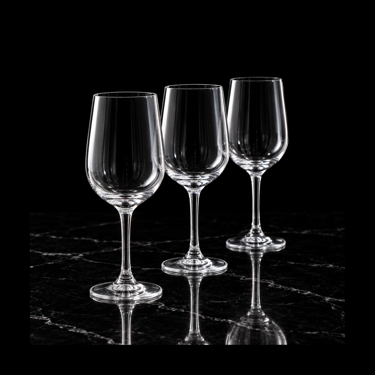 Small crystal wine glasses on black marble