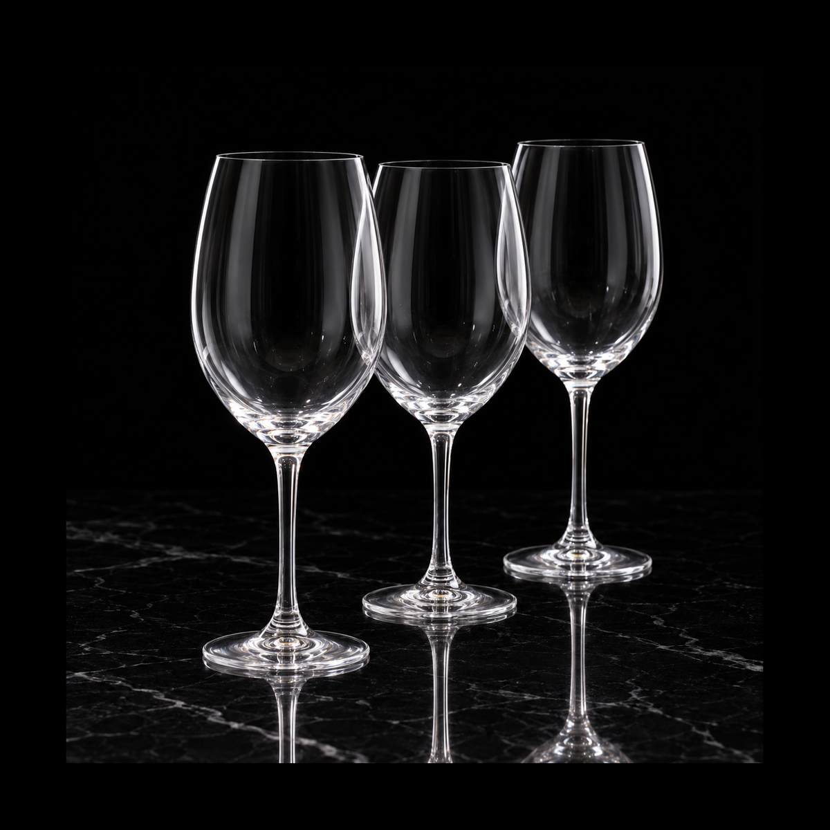 Large crystal wine glasses on black marble