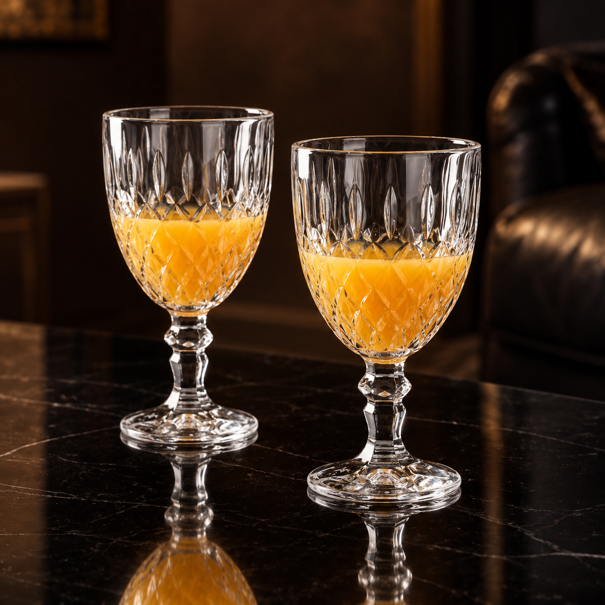 Cut crystal goblets with orange juice in a living room