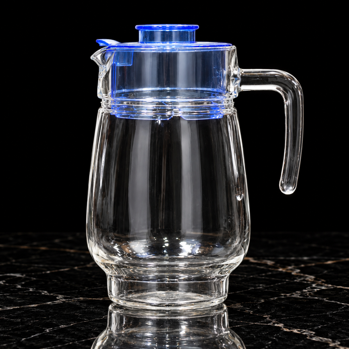 Glass jug set with blue lid on black marble