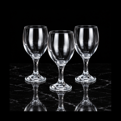 Clear wine goblets on black marble
