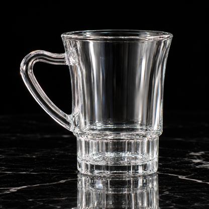 Glass mug with ribbed base on black marble