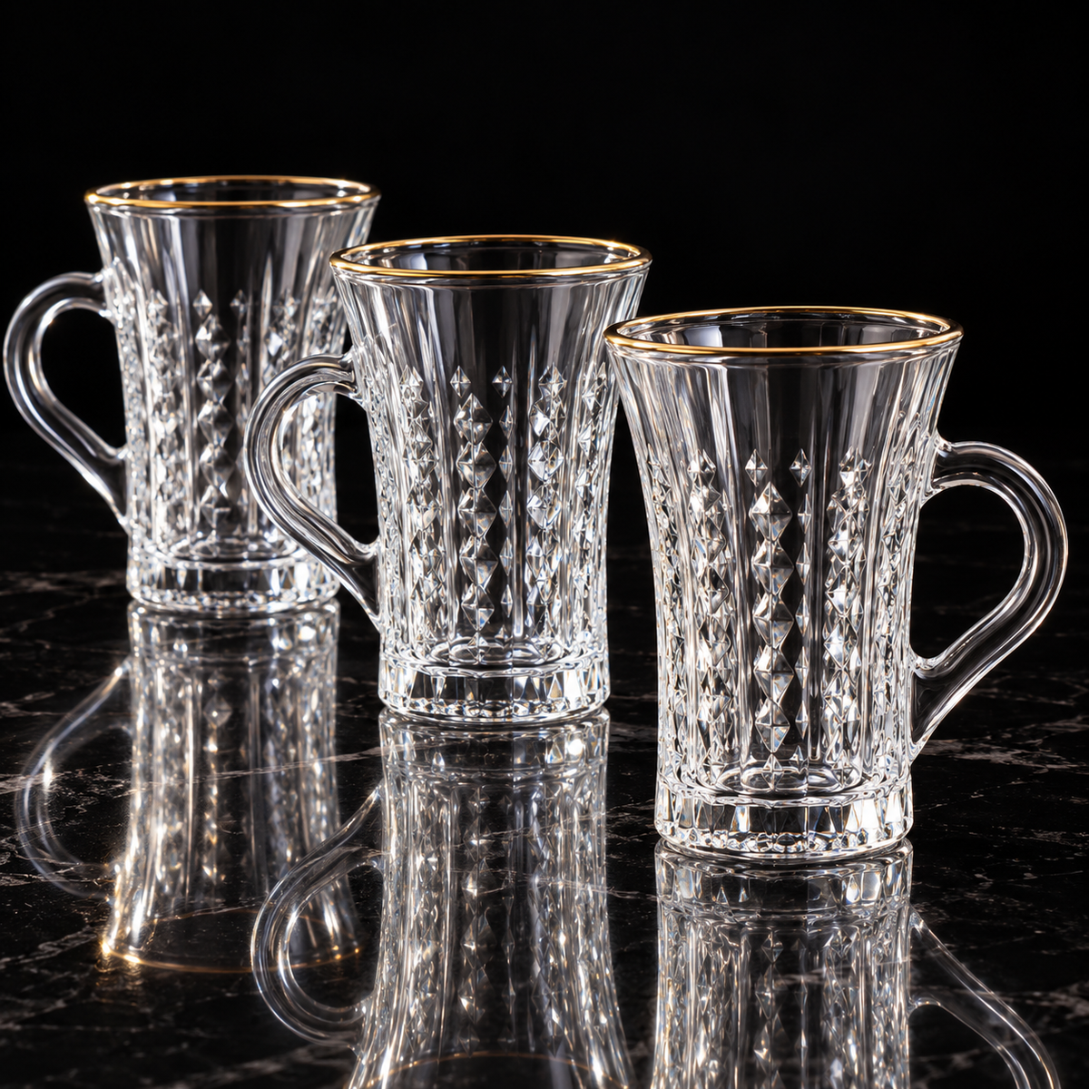 Crystal tea mug with gold rim on black marble