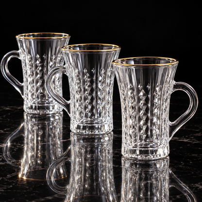 Crystal tea mug with gold rim on black marble