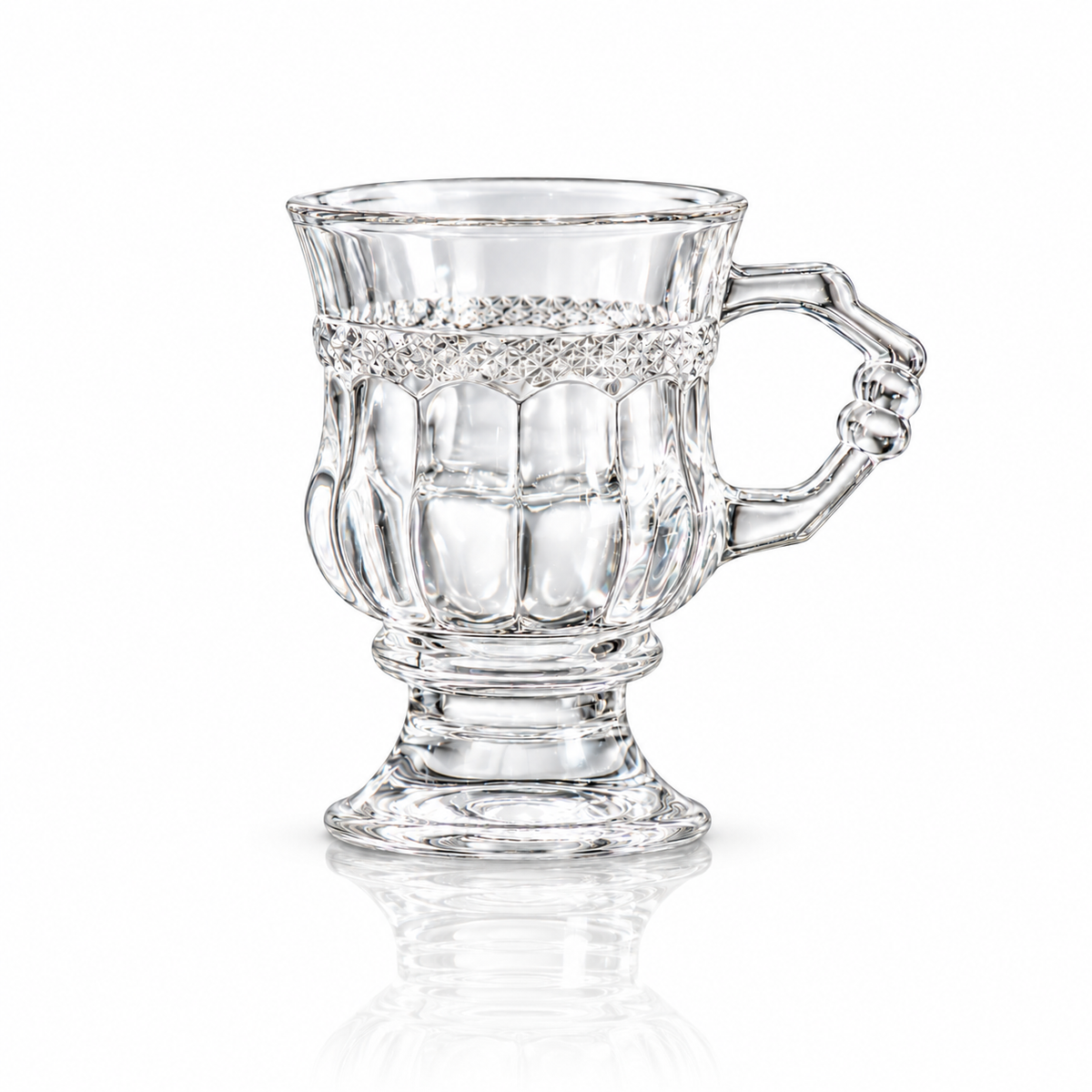 Vintage footed crystal tea glass with diamond-cut band and knuckled handle on white