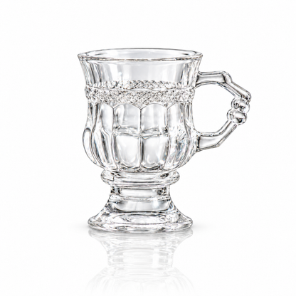 Vintage footed crystal tea glass with diamond-cut band and knuckled handle on white