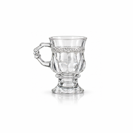 Vintage footed crystal tea glass with diamond-cut band and knuckled handle on white