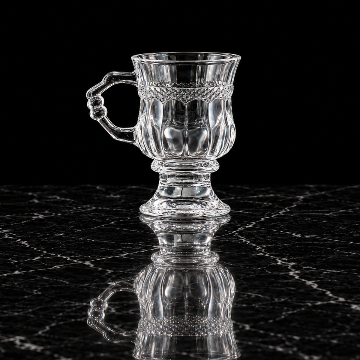 Footed crystal tea glass on black marble