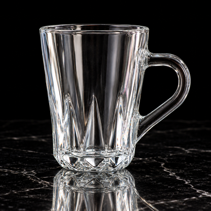 Faceted glass mug on black marble