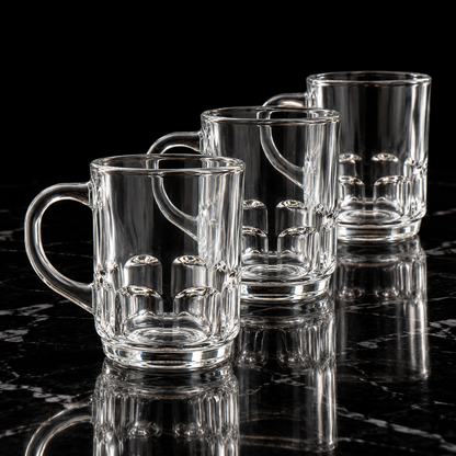 Clear glass mug with dimpled base on black marble