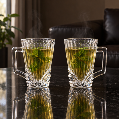 Two ribbed glass cups of mint tea in a living room