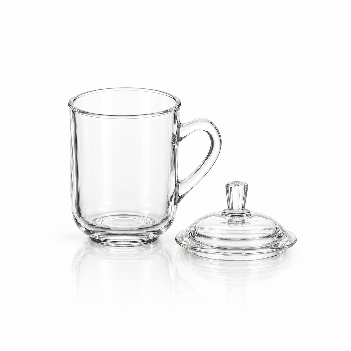 Glass mug with its lid removed beside it