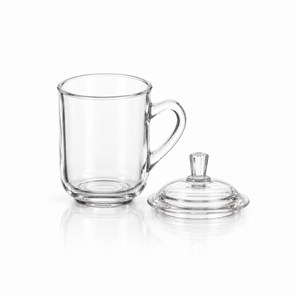 Glass mug with its lid removed beside it