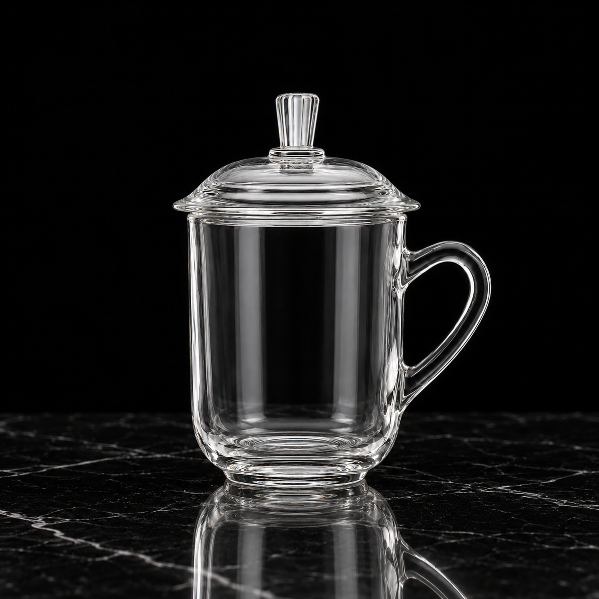 Glass mug with lid on black marble