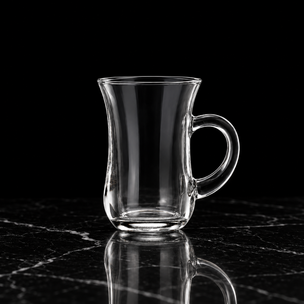 Glass tea cup on black marble
