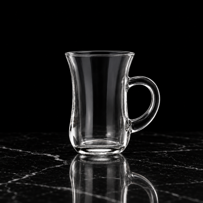 Glass tea cup on black marble