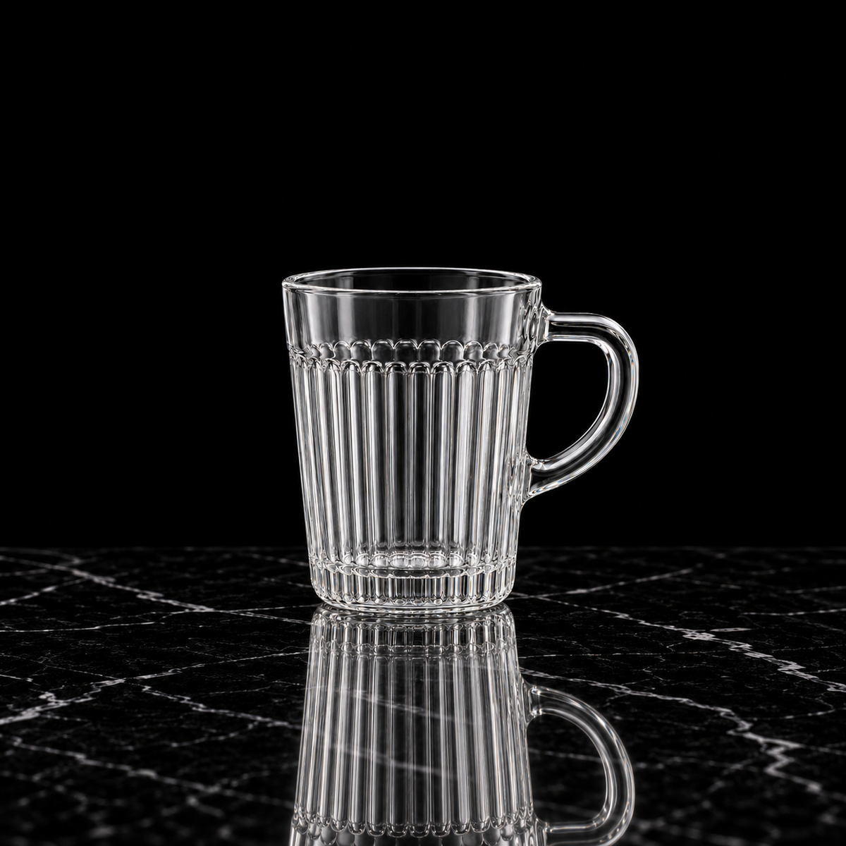 Fluted glass mug on black marble