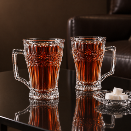 Arch cut glass tea mugs with tea and sugar cubes in a living room