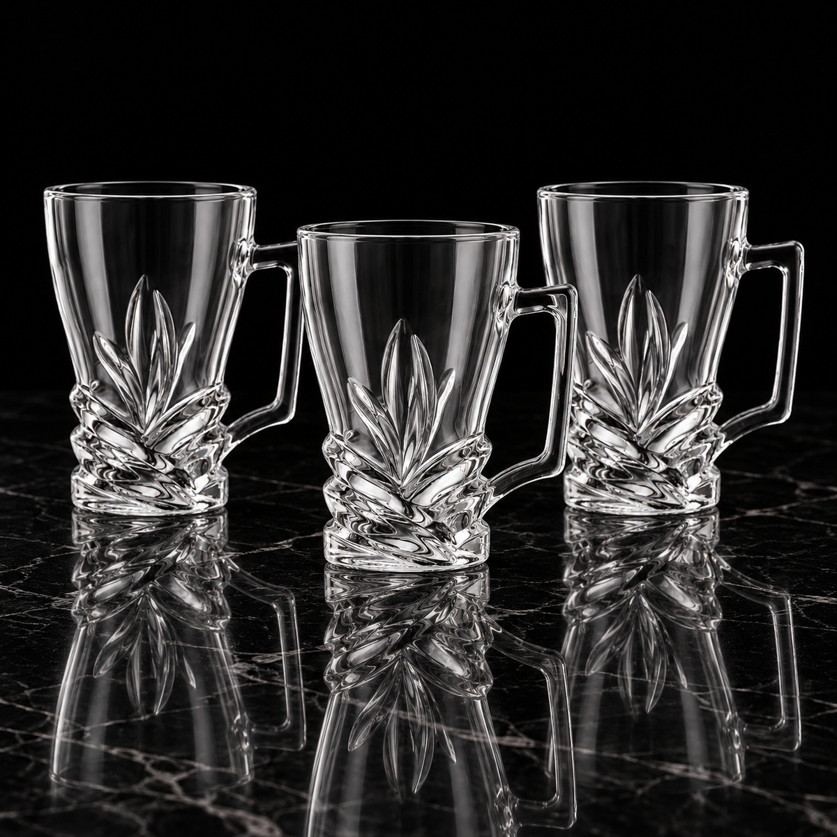 Leaf cut glass tea mugs on black marble