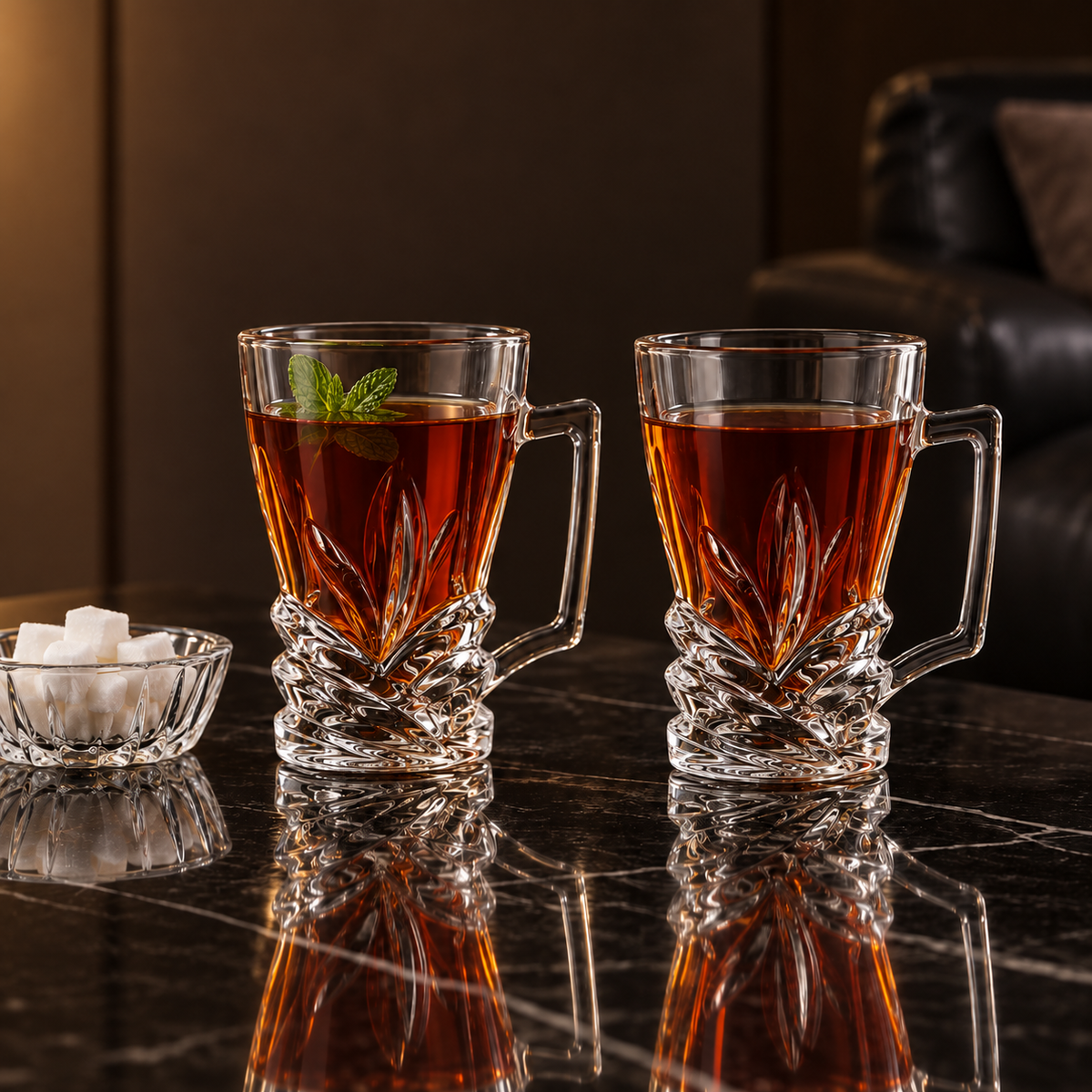 Leaf cut glass tea mugs with mint tea in a living room