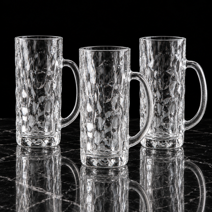 Tall hammered glass mugs on black marble