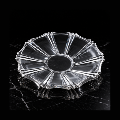 Clear glass serving plate on black marble