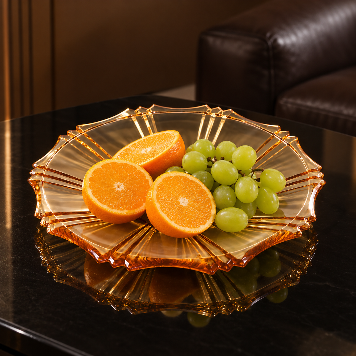 Amber plate with oranges and grapes in a living room