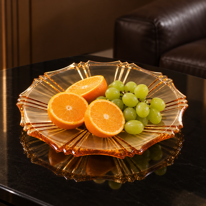 Amber plate with oranges and grapes in a living room