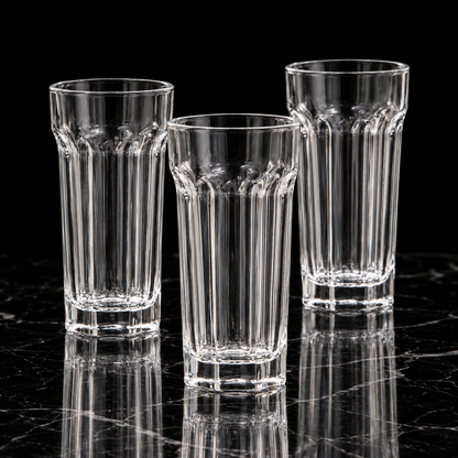 Paneled crystal highball glass on black marble