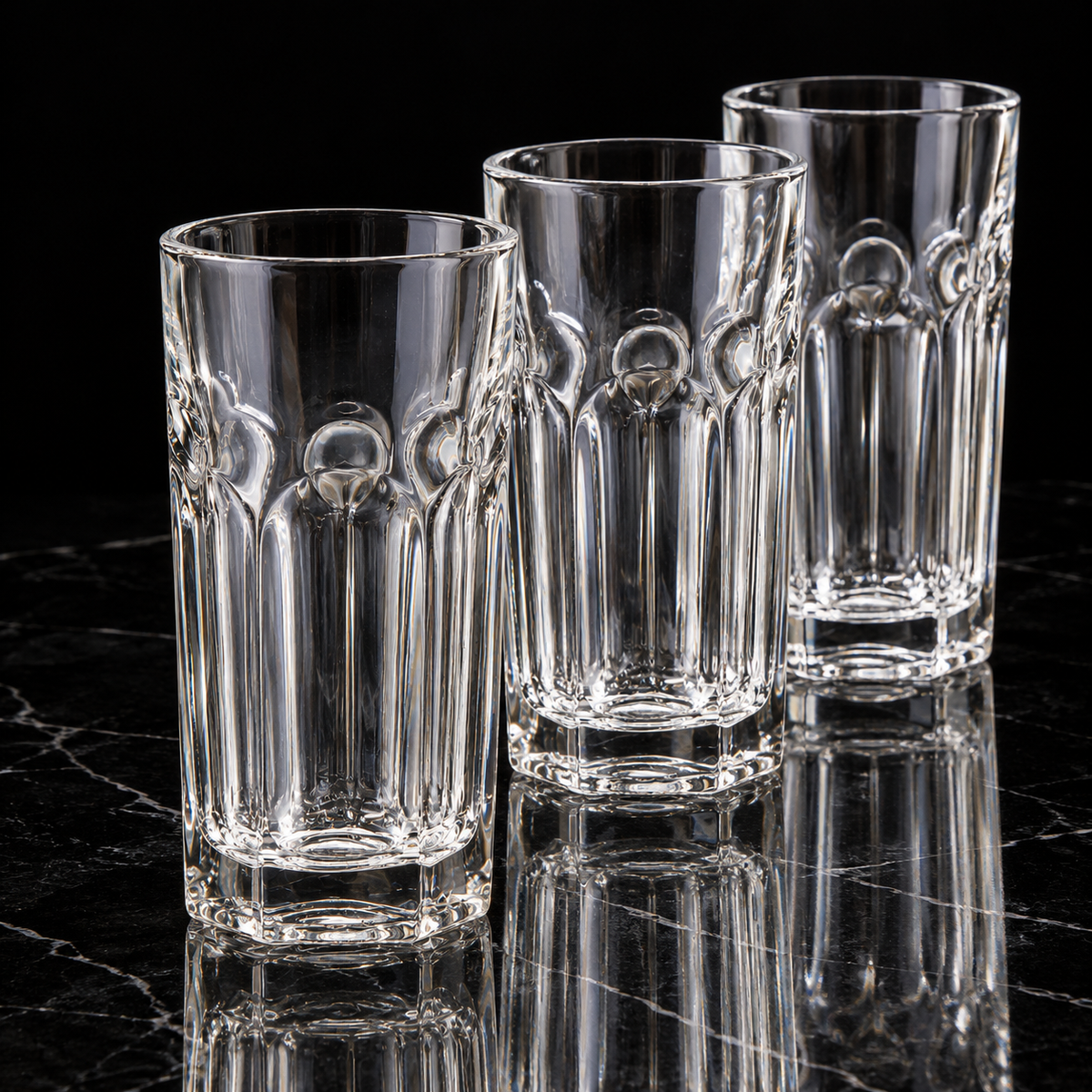 Fluted crystal highball glass on black marble