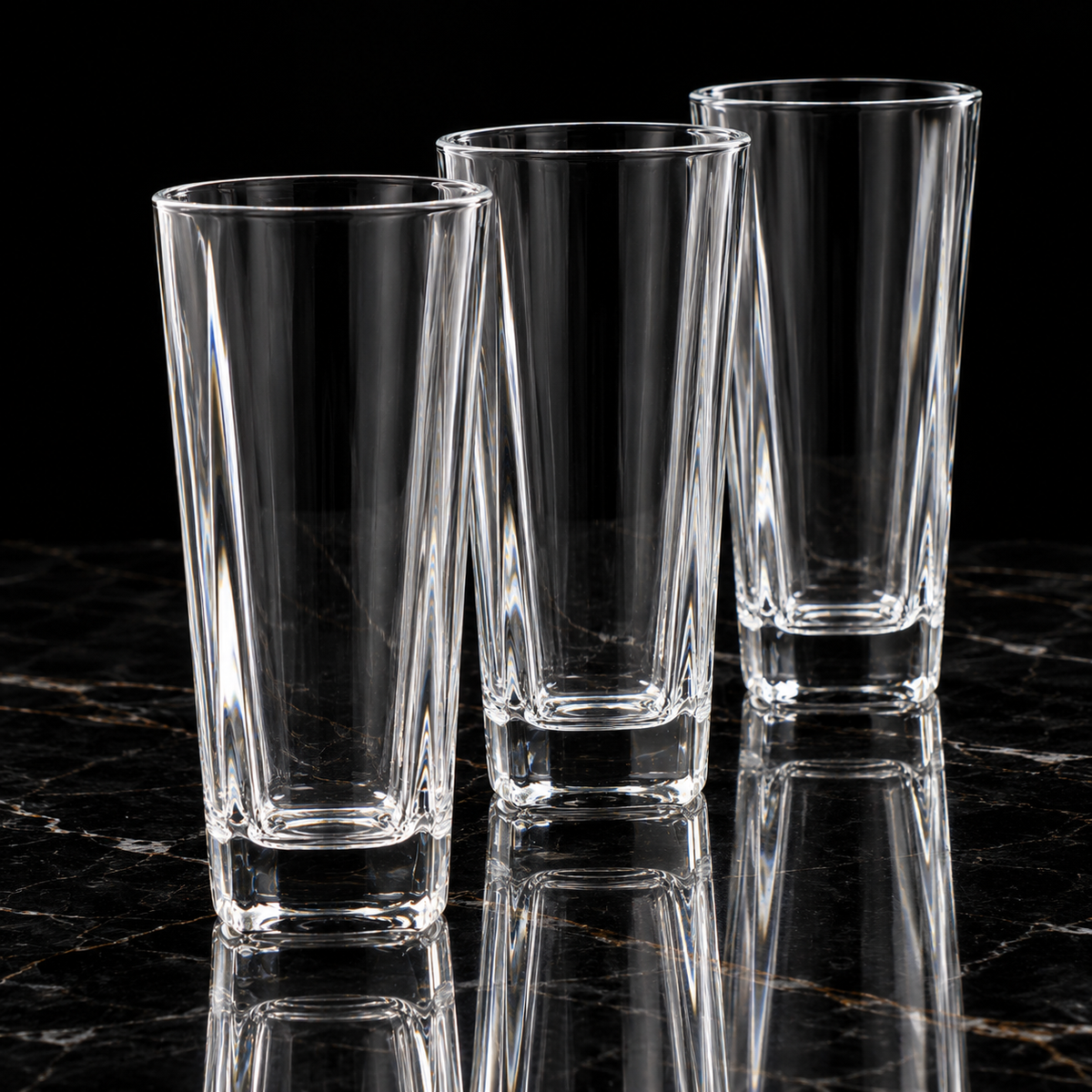 Faceted crystal highball glass on black marble