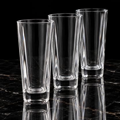 Faceted crystal highball glass on black marble