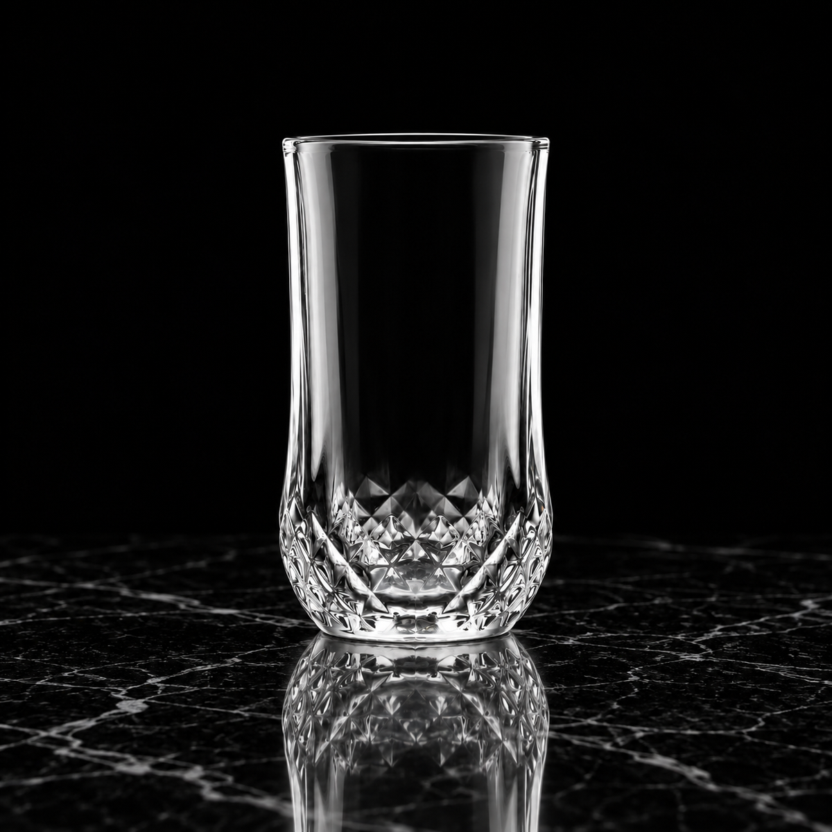 T-140 diamond-cut highball glass on black marble