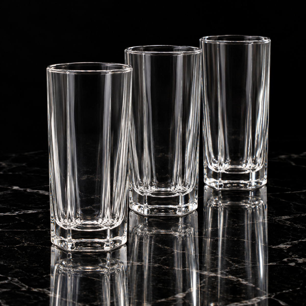 Octagonal crystal highball glass on black marble