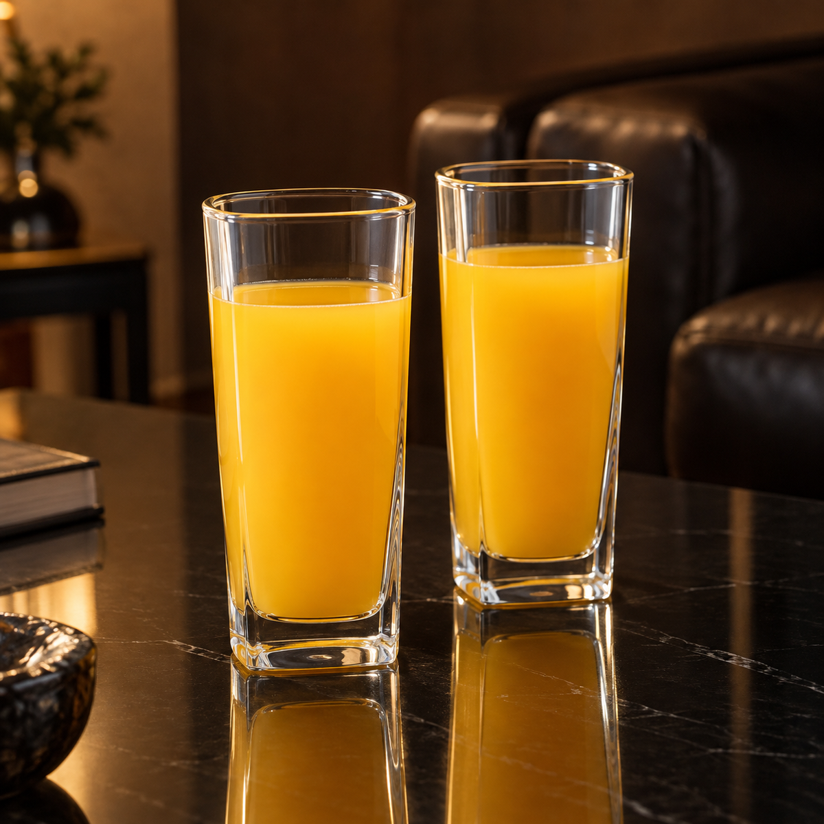 Highball glasses with orange juice in living room